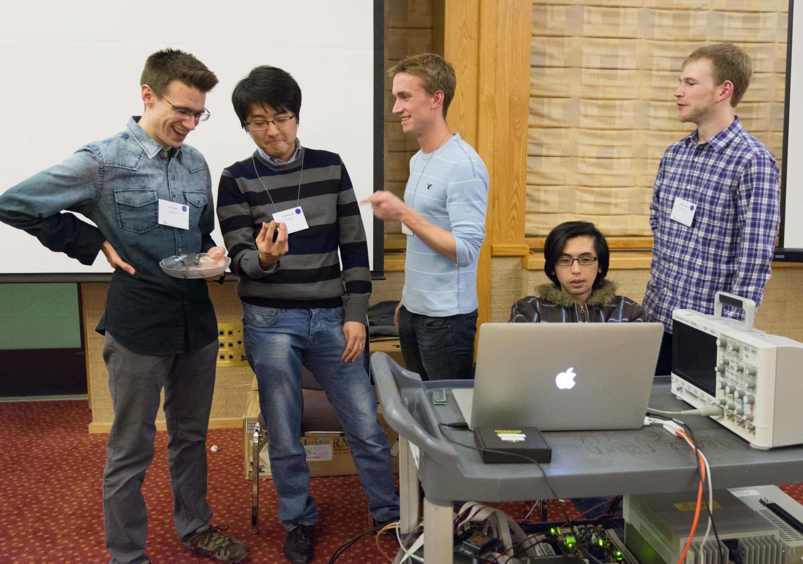 Berkeley students talking and laughing near demo equipment