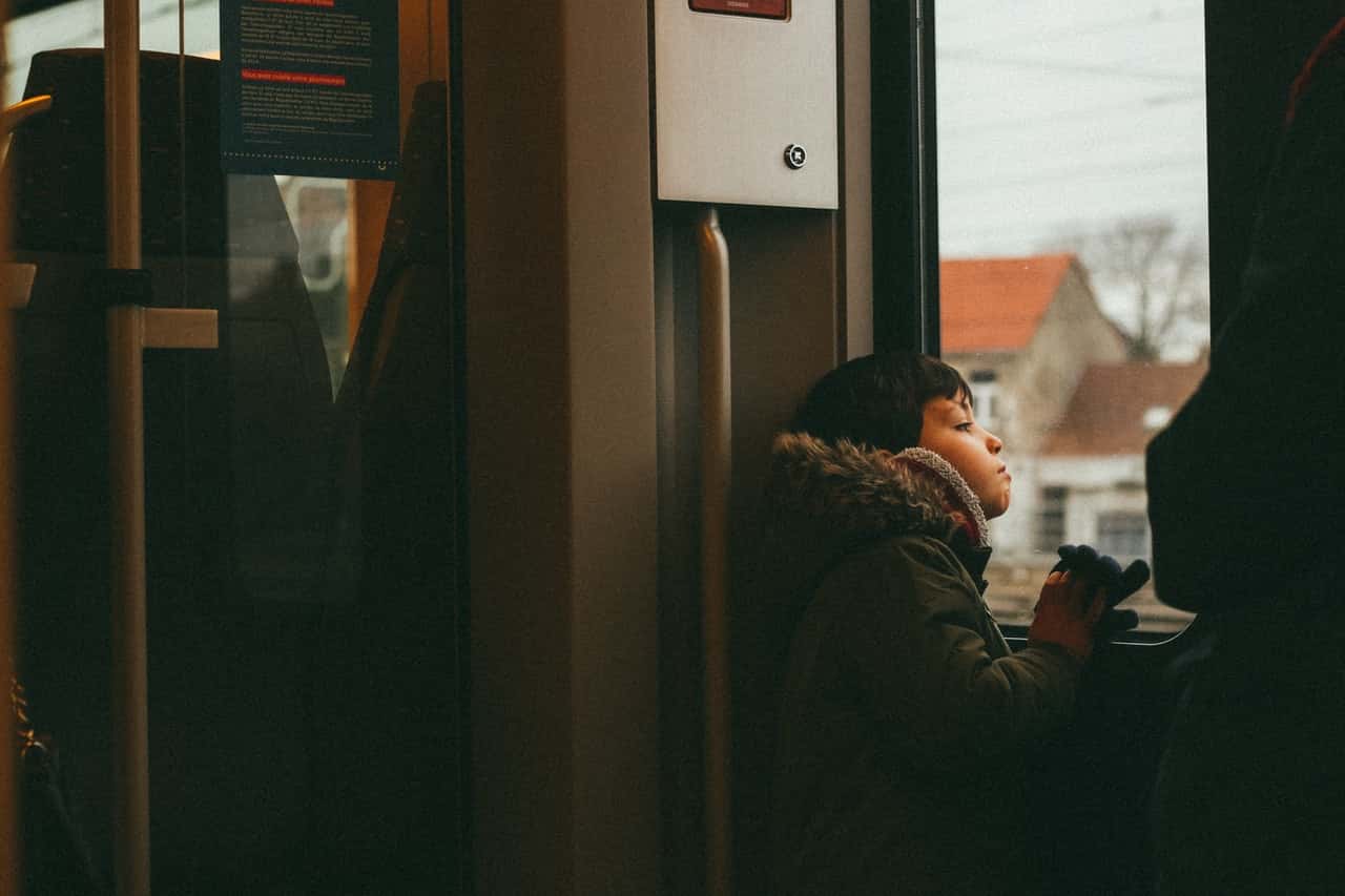 boy-wearing-fur-jacket-inside-a-train-3921017