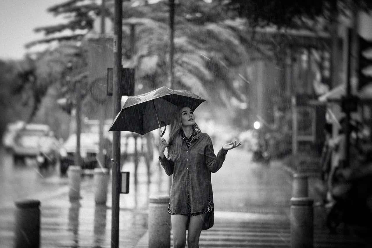 grayscale-photo-of-woman-holding-an-umbrella-4005513