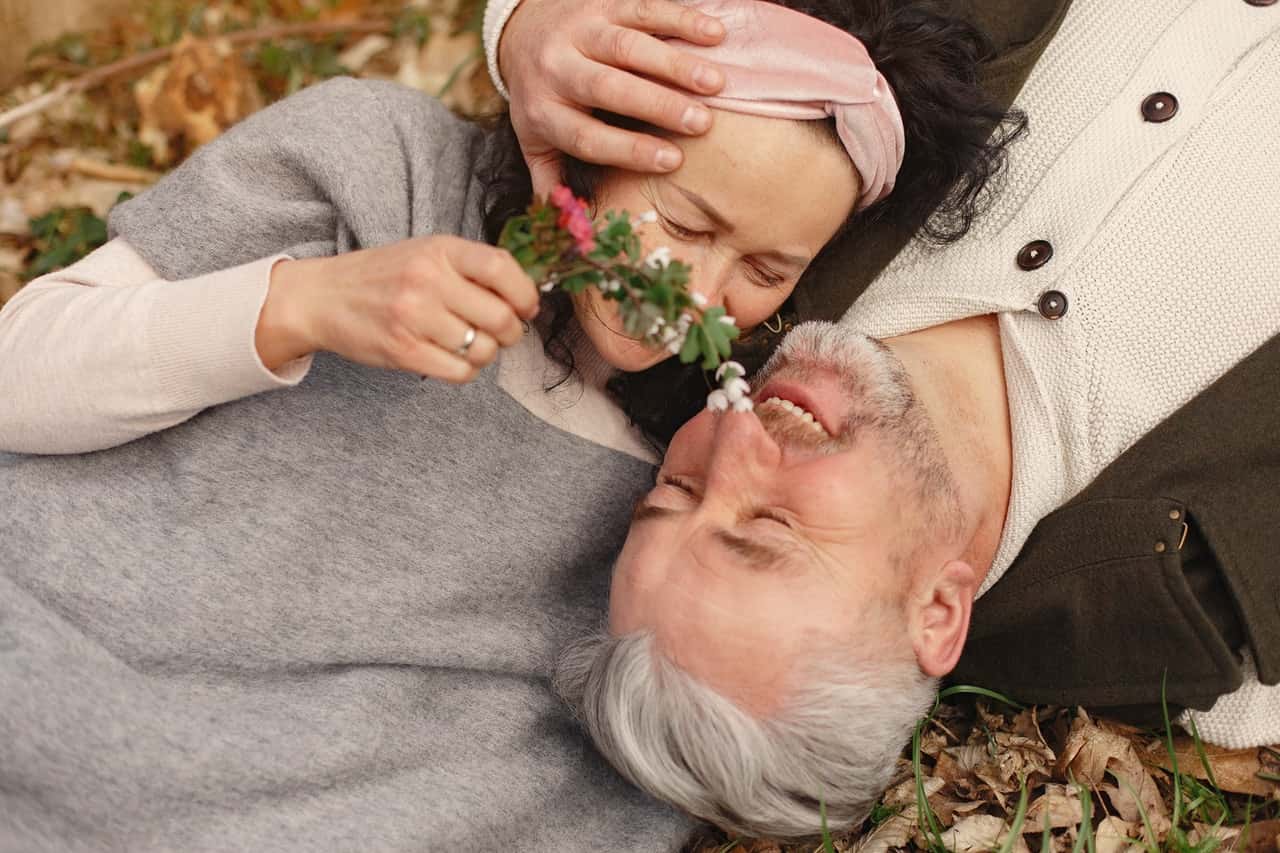 happy-senior-couple-in-love-with-bunch-of-fresh-flowers-in-4148984