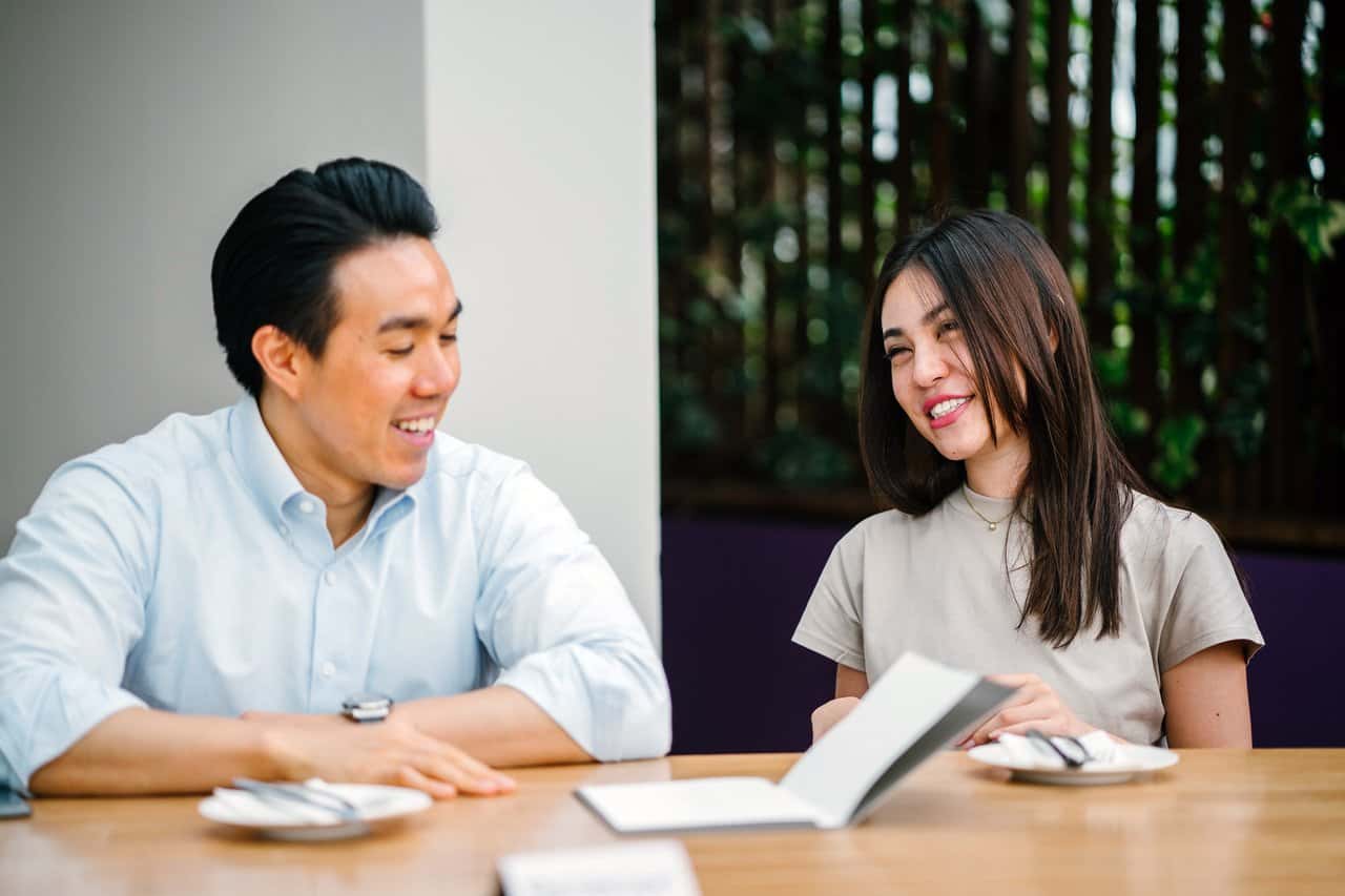 man-and-woman-sitting-on-chair-in-front-of-desk-1346197