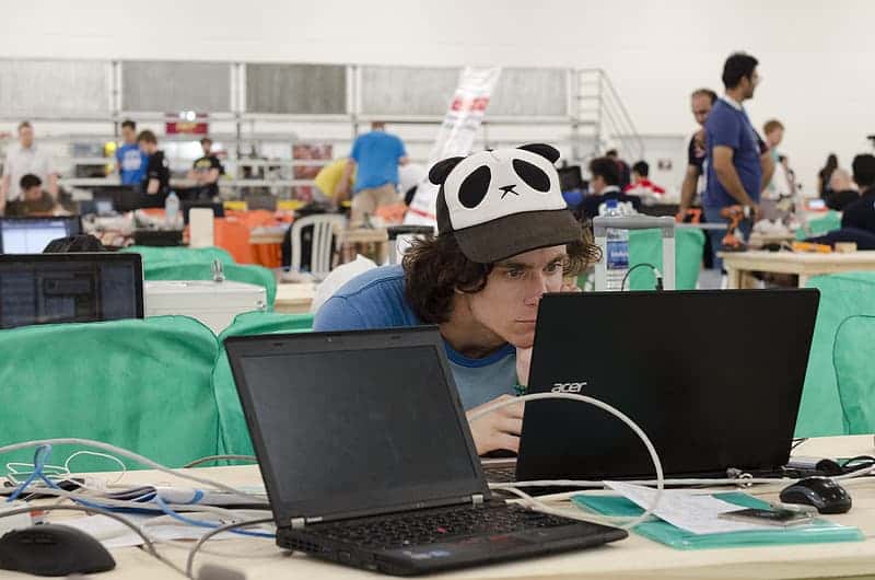 man-in-blue-shirt-using-laptop-computer