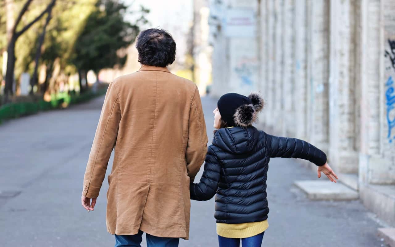 man-in-brown-coat-and-woman-in-black-and-yellow-striped-long-3843777