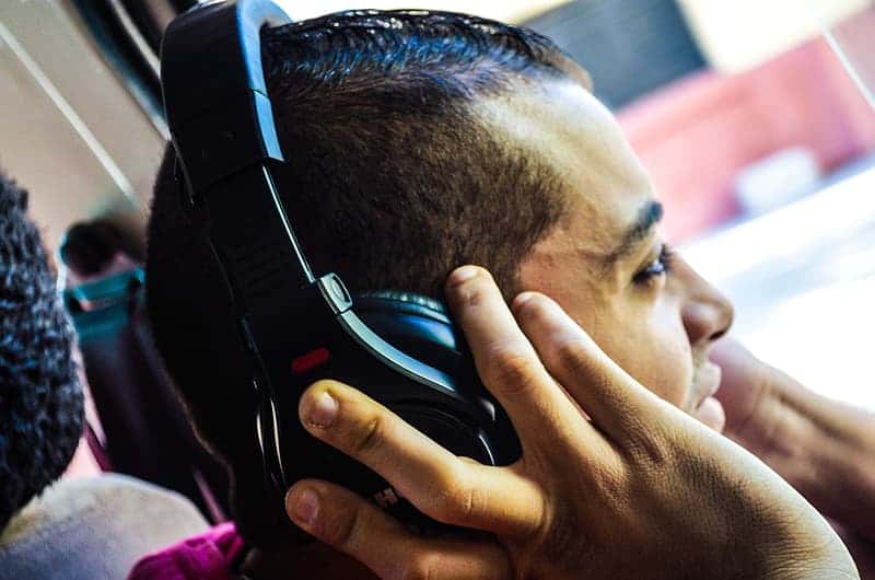 man-in-pink-shirt-wearing-black-headphones