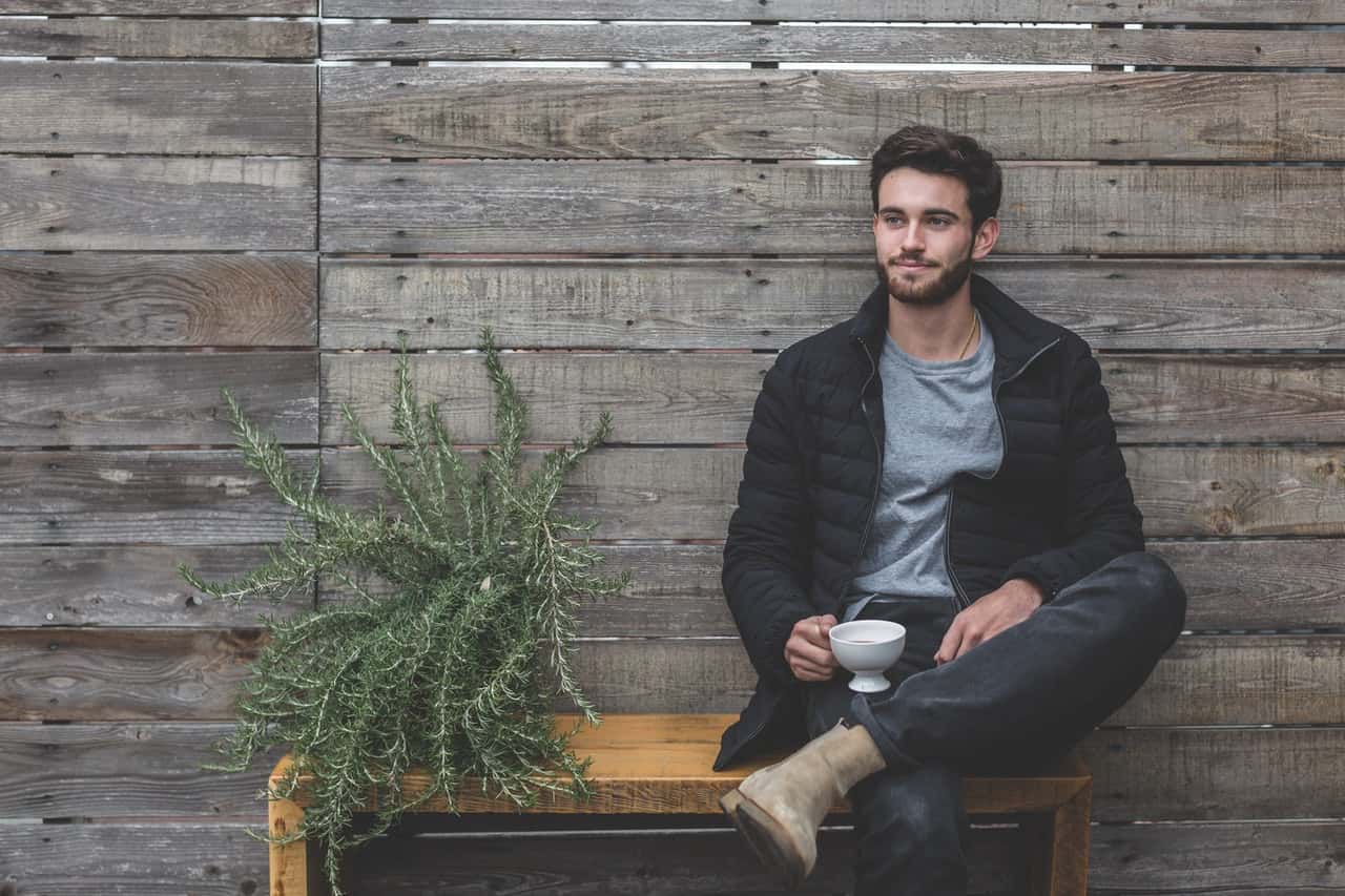 man-sitting-on-bench-having-a-cup-of-coffee-374044