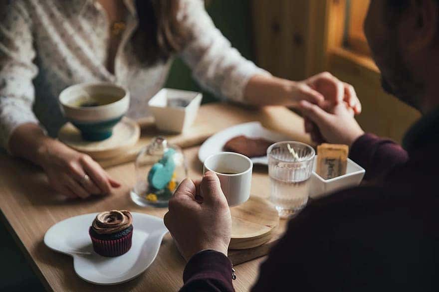 people-man-woman-couple-holding-hands-dinner-date-restaurant-coffeehouse