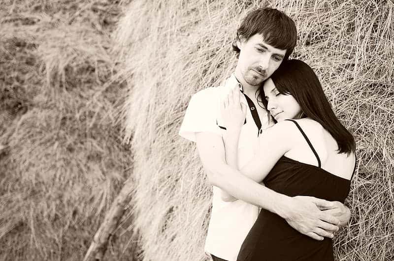 photo-of-couple-hugging-beside-haystack