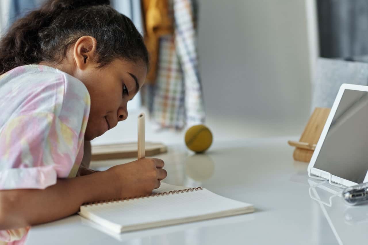 photo-of-girl-writing-on-white-paper-4143794