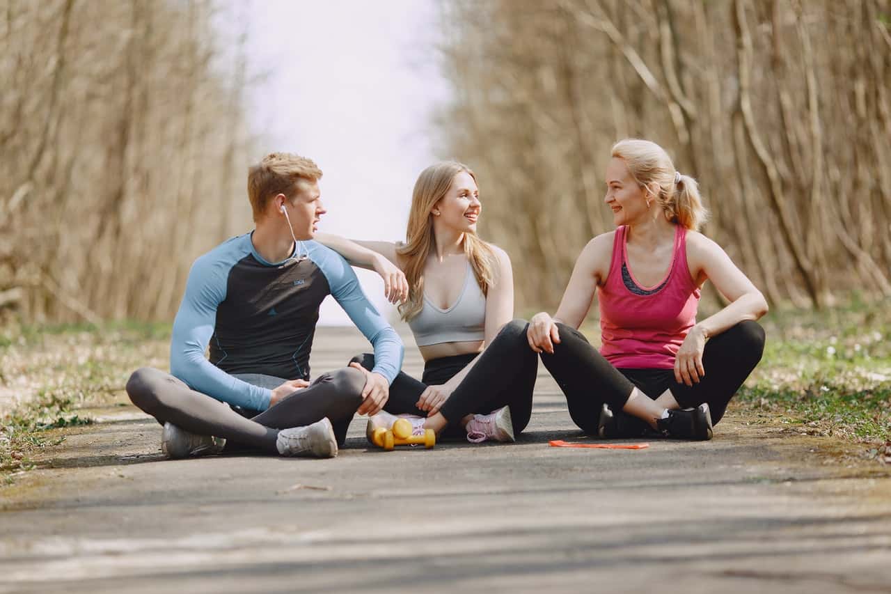 photo-of-man-and-women-sitting-on-pavement-while-talking-4148946