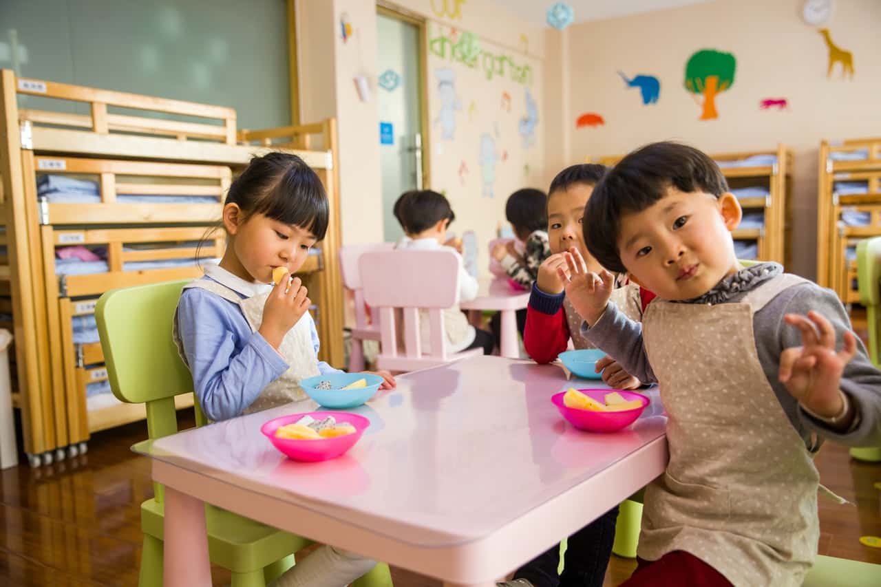 three-toddler-eating-on-white-table-1001914