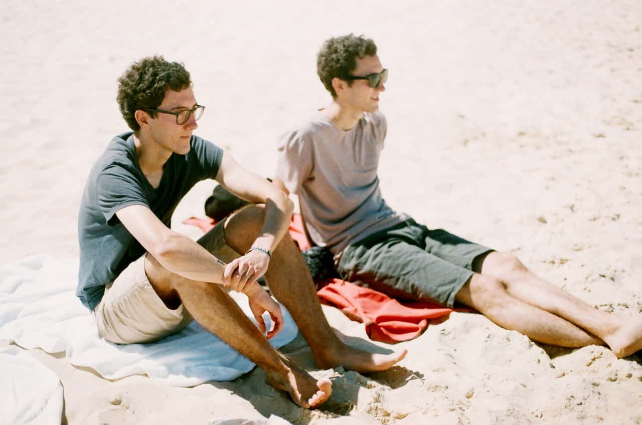 two-guys-sitting-by-the-beach-1697311