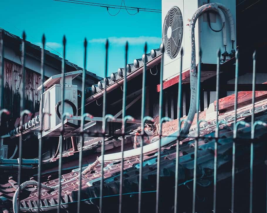 two-white-ac-condenser-units-mounted-on-roof