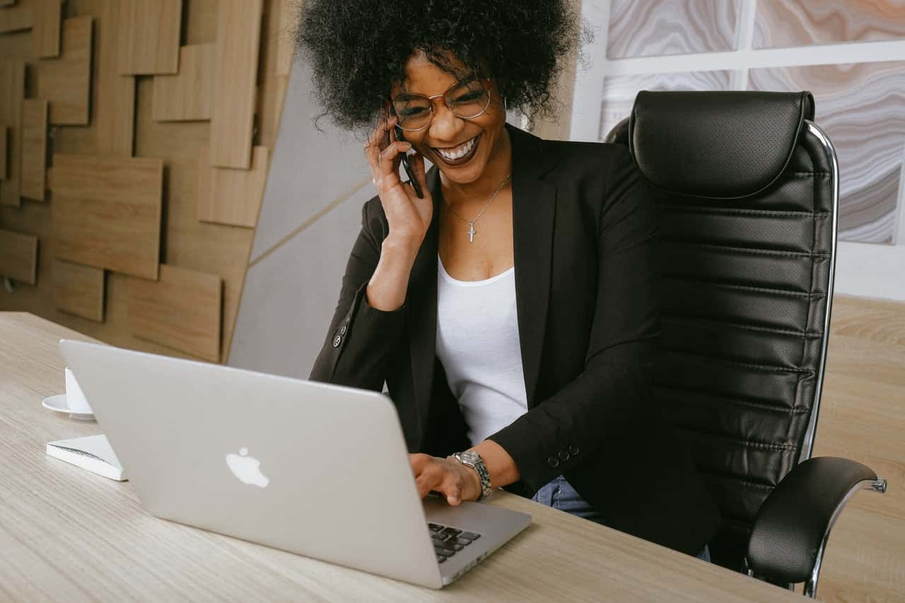 woman-in-black-blazer-sitting-on-black-office-chair-3727464