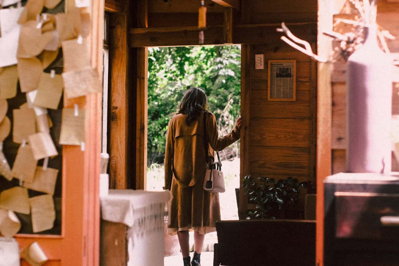 woman-standing-near-open-door-about-to-step-outside-2297663