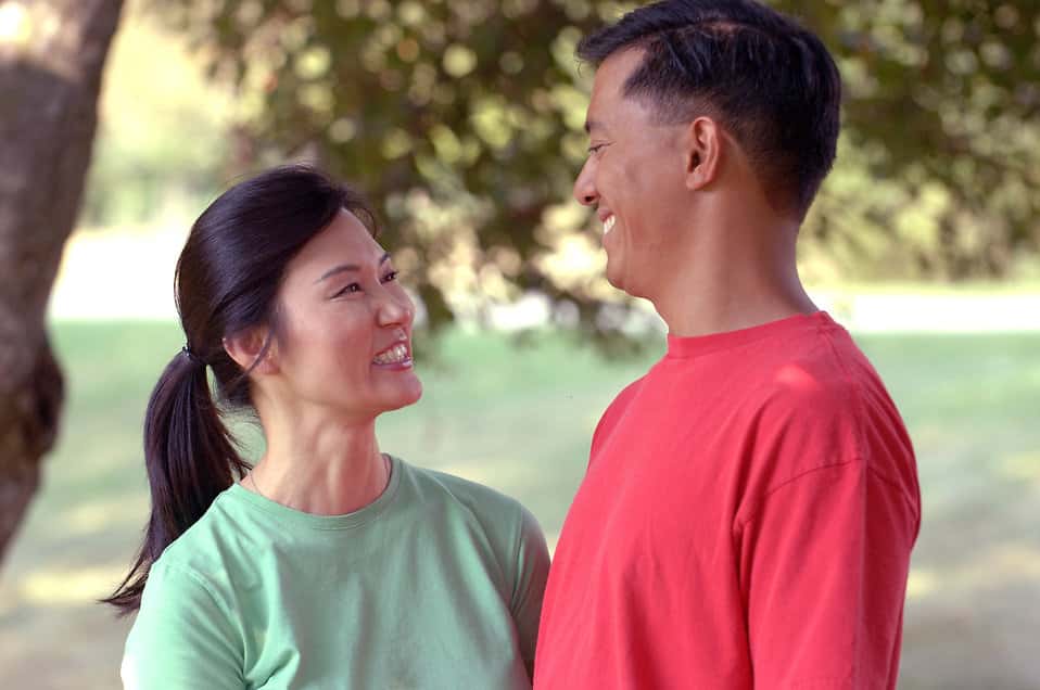 17066-an-asian-couple-smiling-at-each-other-outdoors-pv