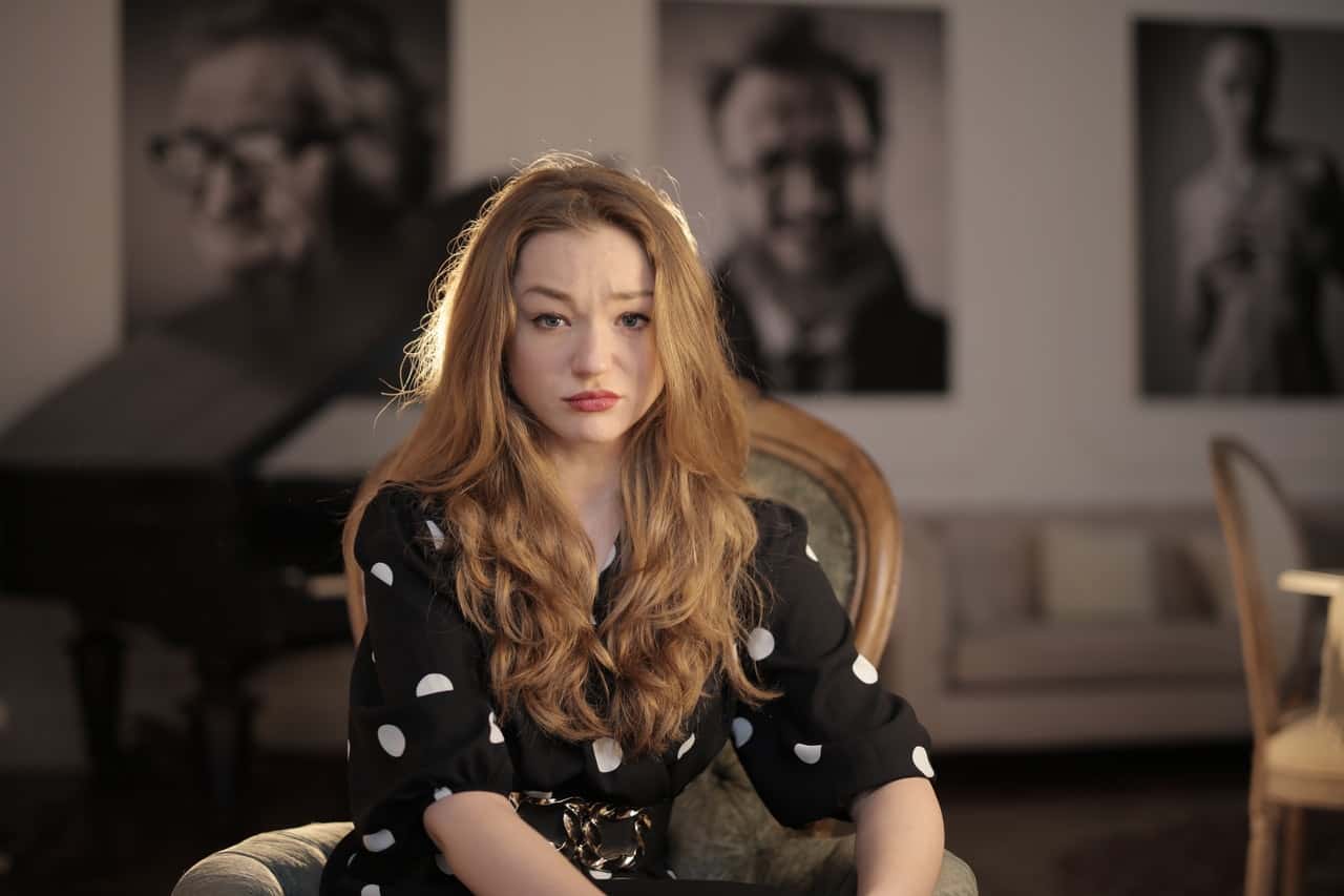 a-sad-woman-in-black-and-white-polka-dot-shirt-sitting-on-3783800