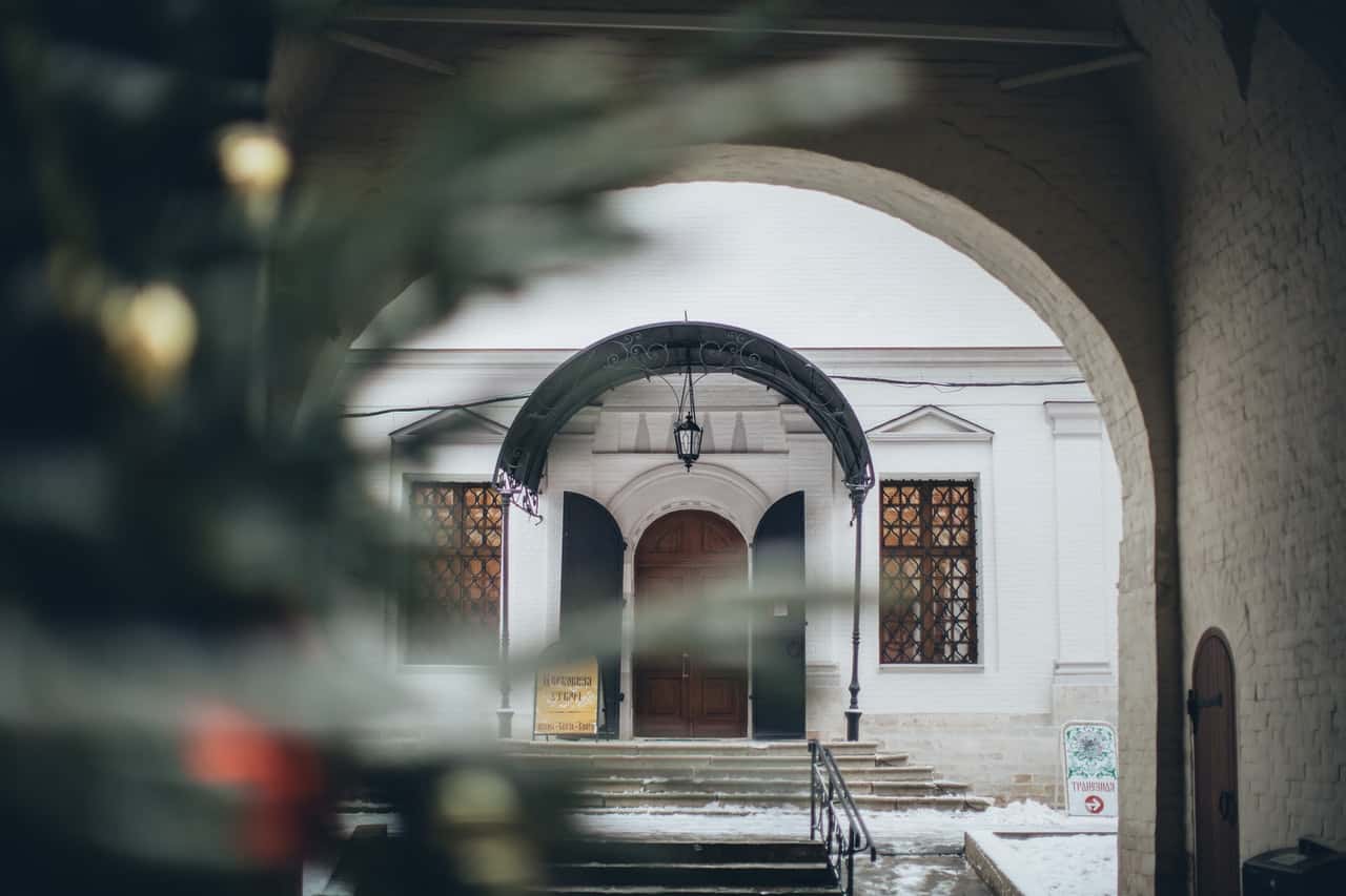 arched-entrance-of-old-church-in-winter-3811103