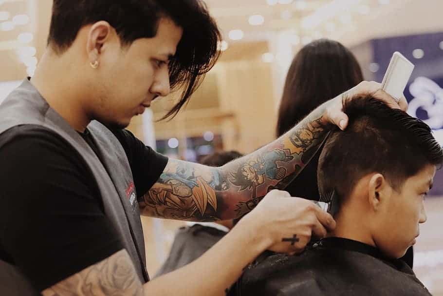 barber-using-hair-trimmer-on-boy-s-hair
