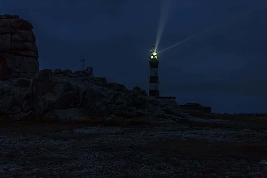 lighted-lighthouse-during-night-time