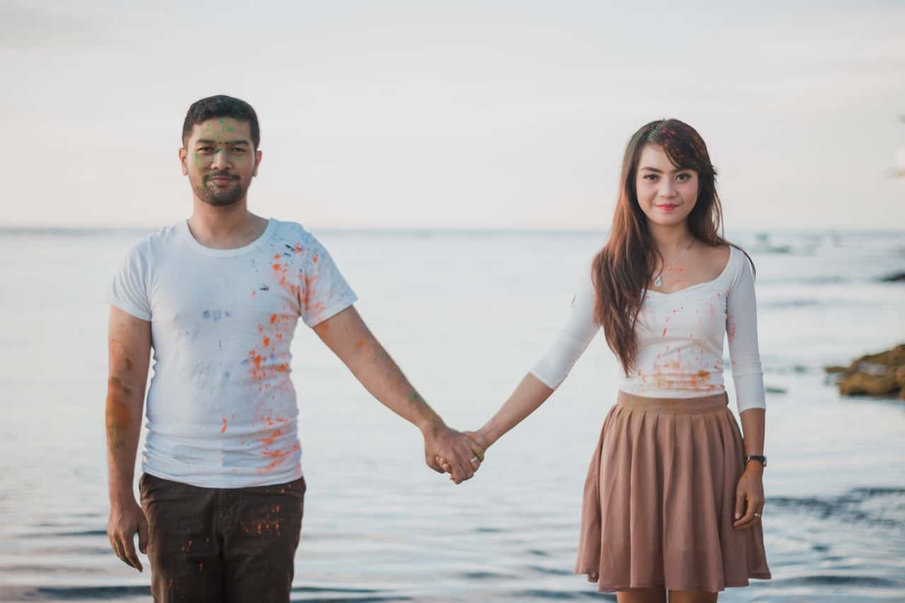 man-and-woman-standing-beside-body-of-water-1179975