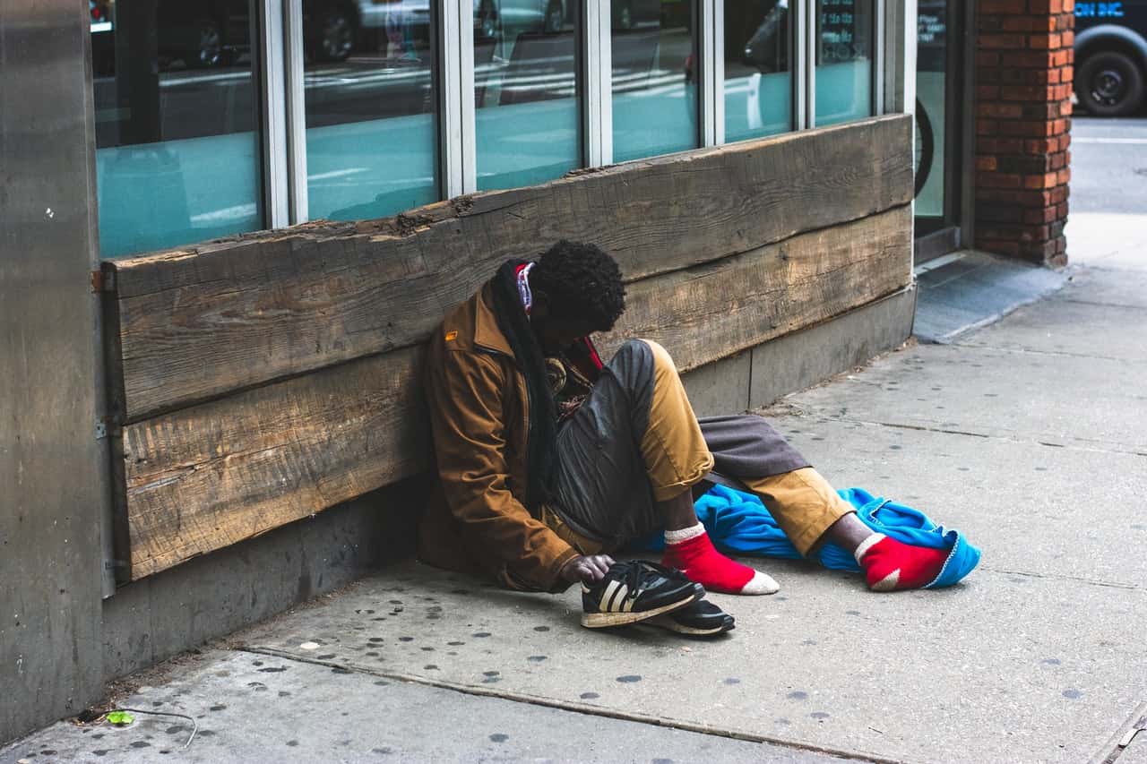 man-sitting-on-street-2239908