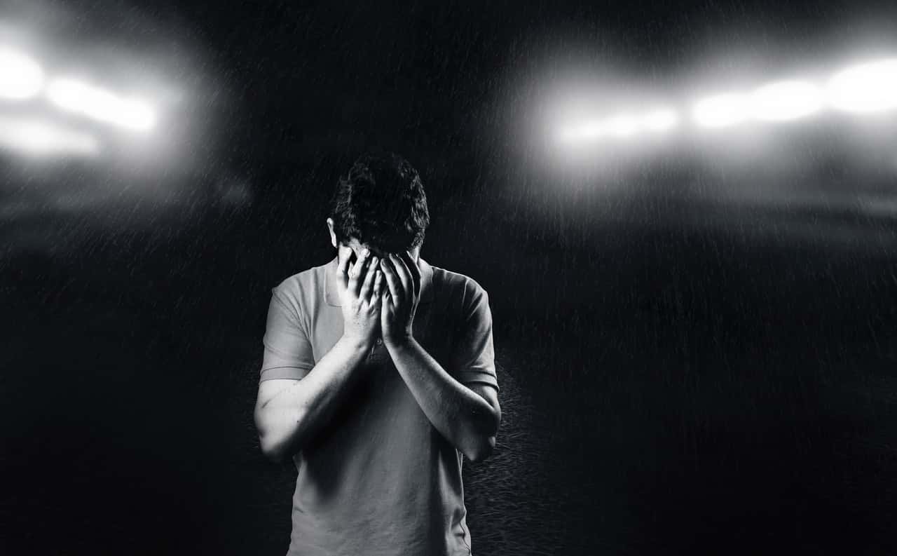 monochrome-photo-of-man-covering-his-face-1556716