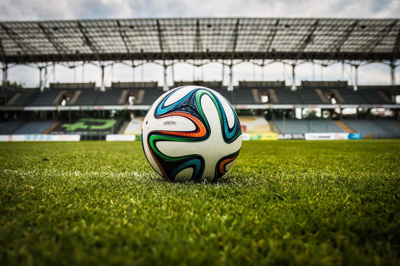 multicolored-soccer-ball-on-green-field-47730