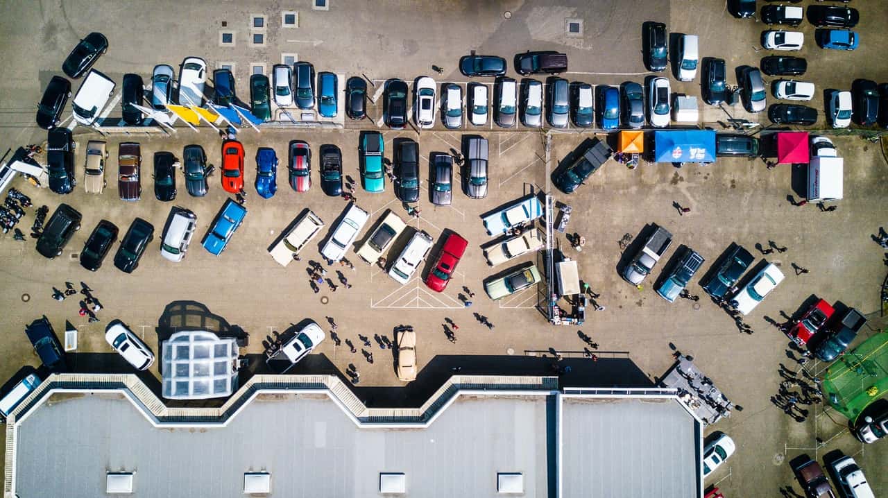 photo-from-above-of-vehicles-parked-near-building-753876