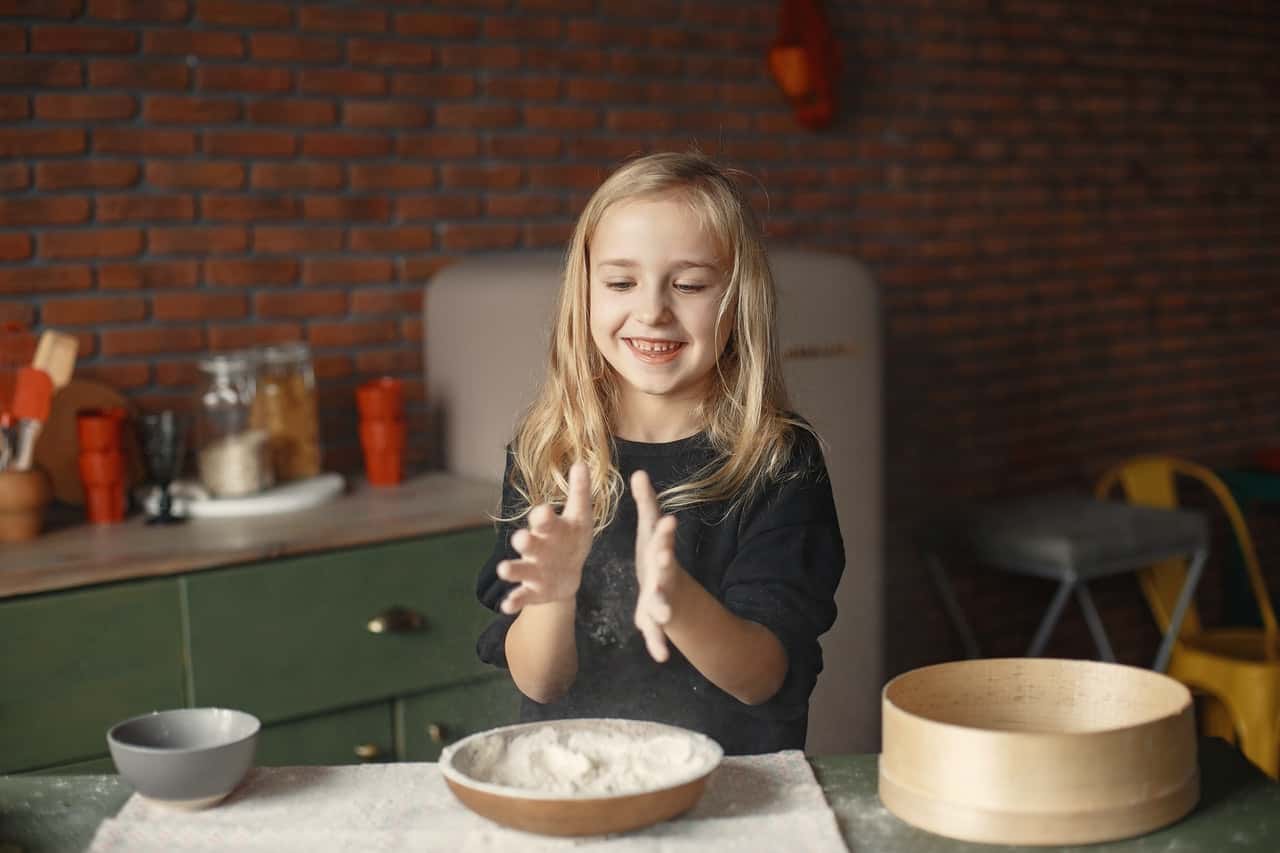 playful-little-girl-with-flour-in-loft-style-kitchen-3984748