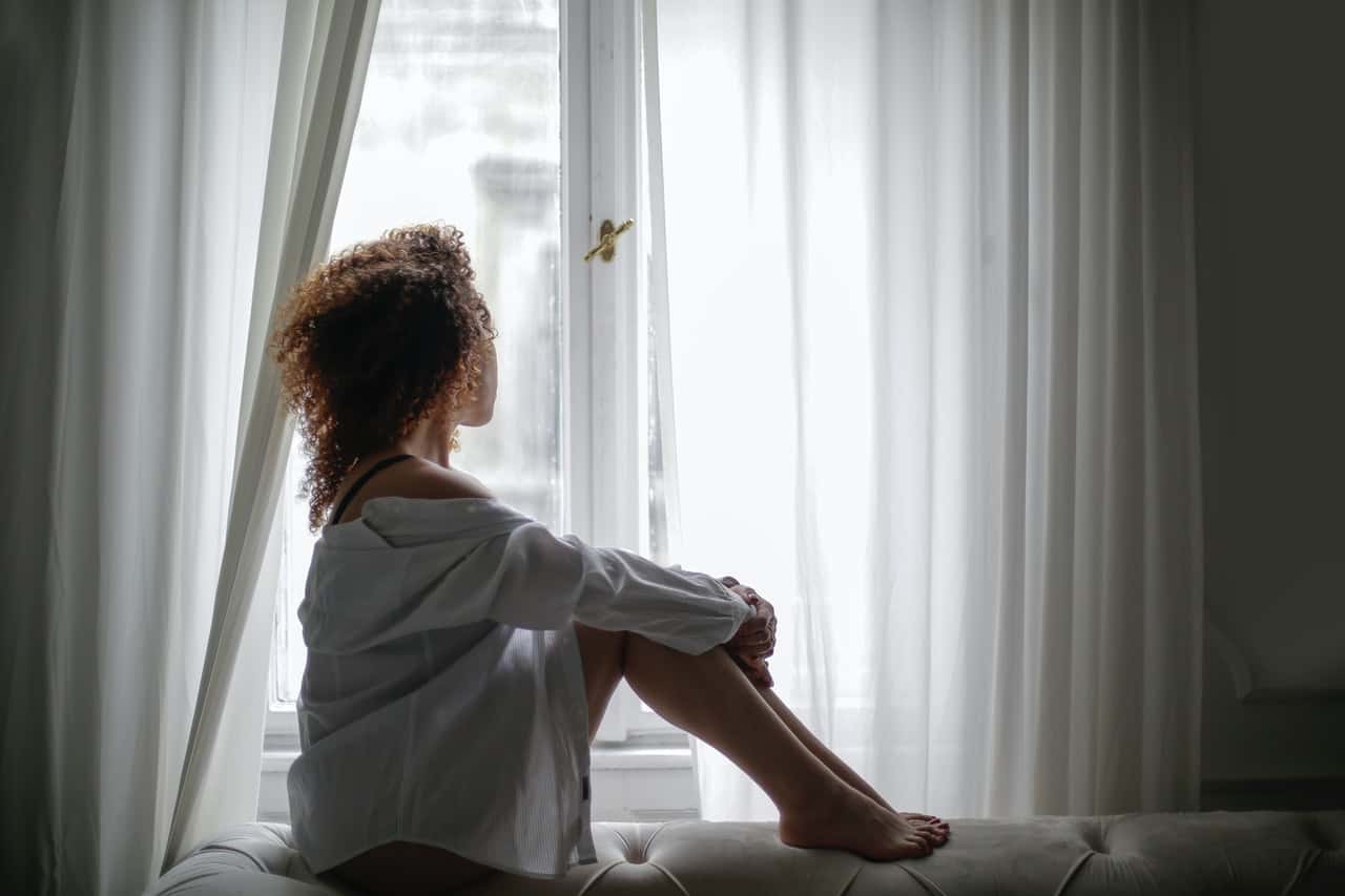 sensual-young-ethnic-lady-sitting-on-sofa-and-looking-3967034