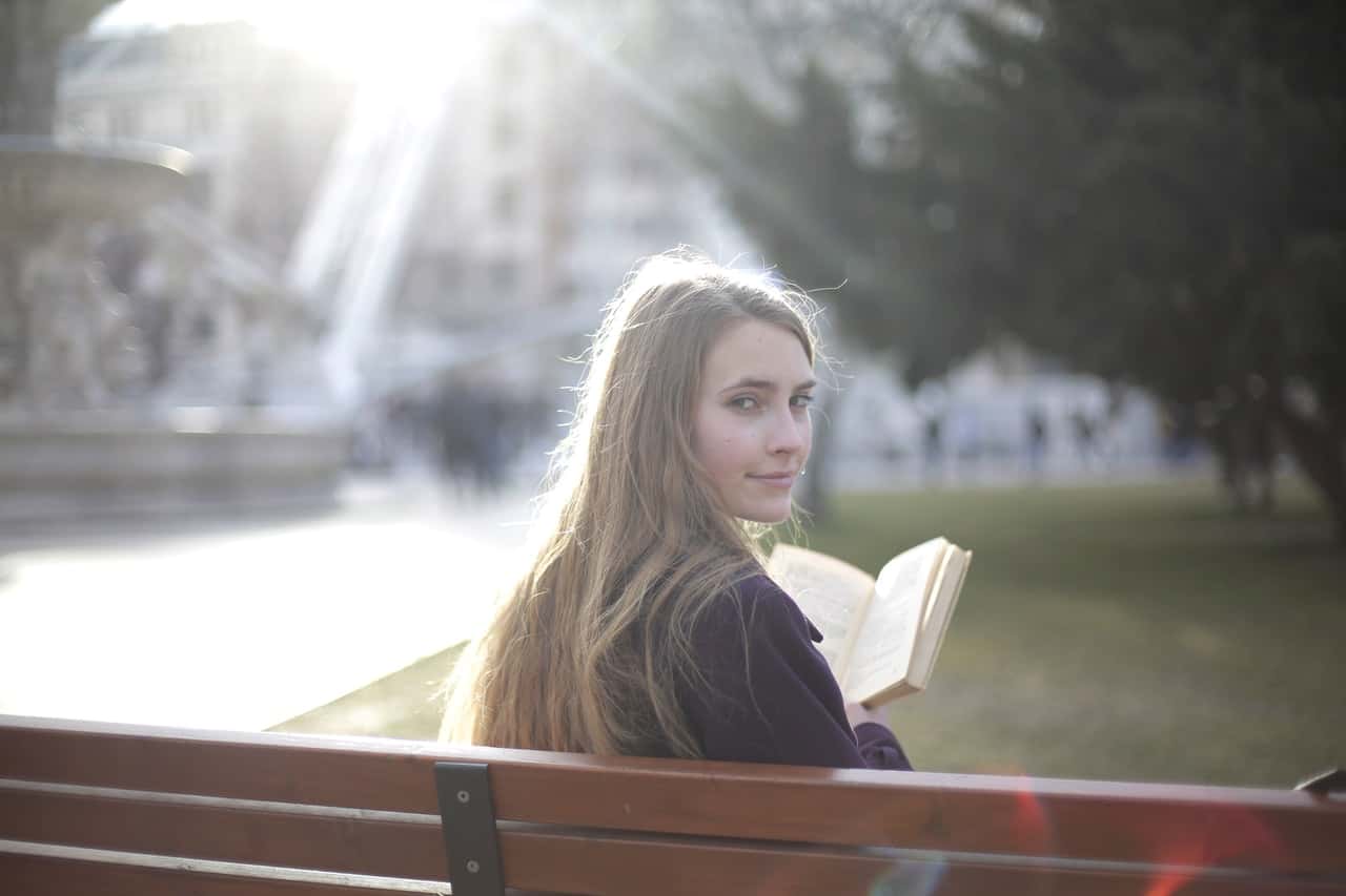tranquil-woman-reading-book-in-park-3796612
