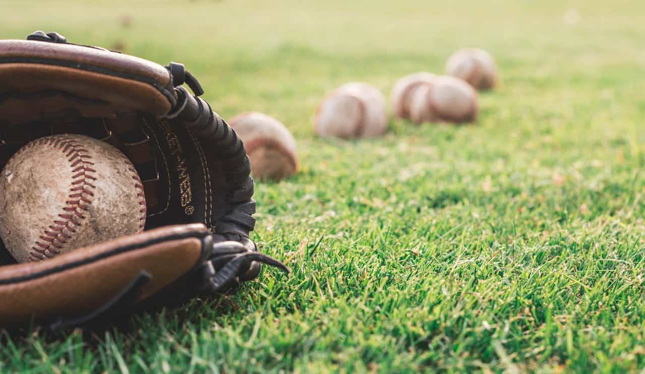 white-baseball-ball-on-brown-leather-baseball-mitt-1661950