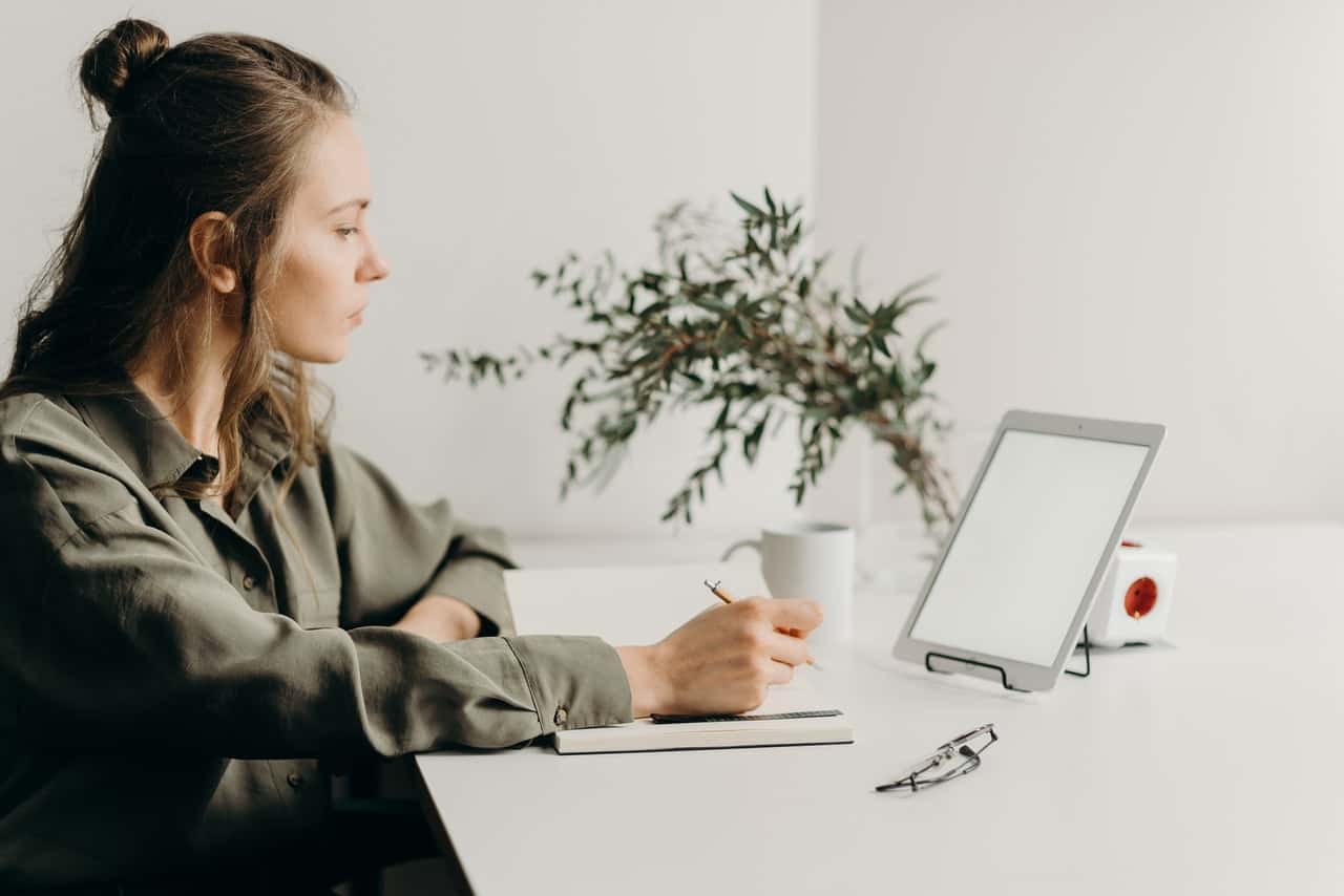 woman-in-gray-coat-using-white-laptop-computer-4065891