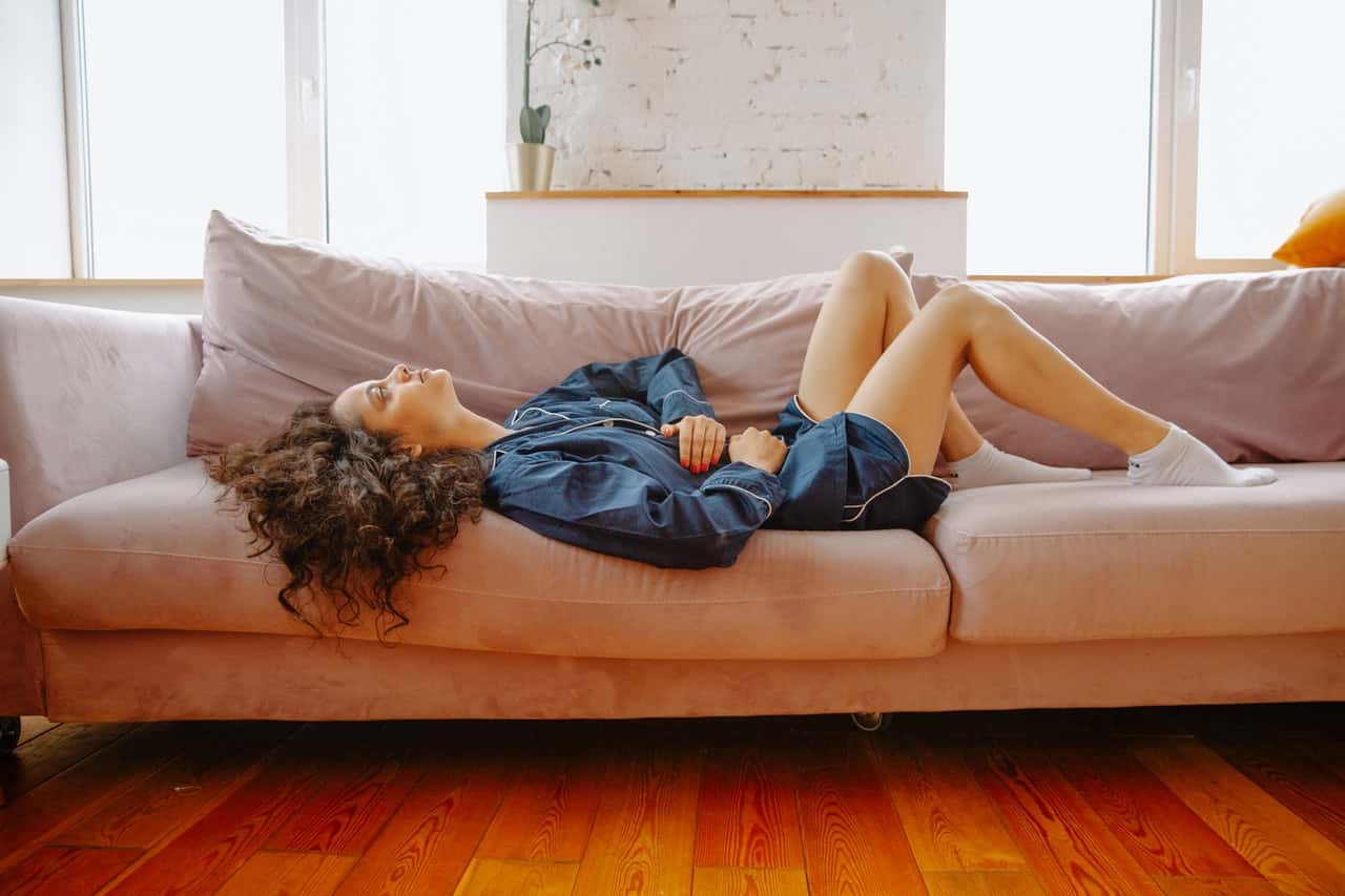 woman-lying-on-couch-3958561