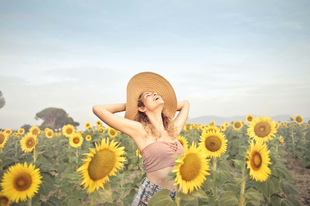 woman-standing-on-sunflower-field-3764579