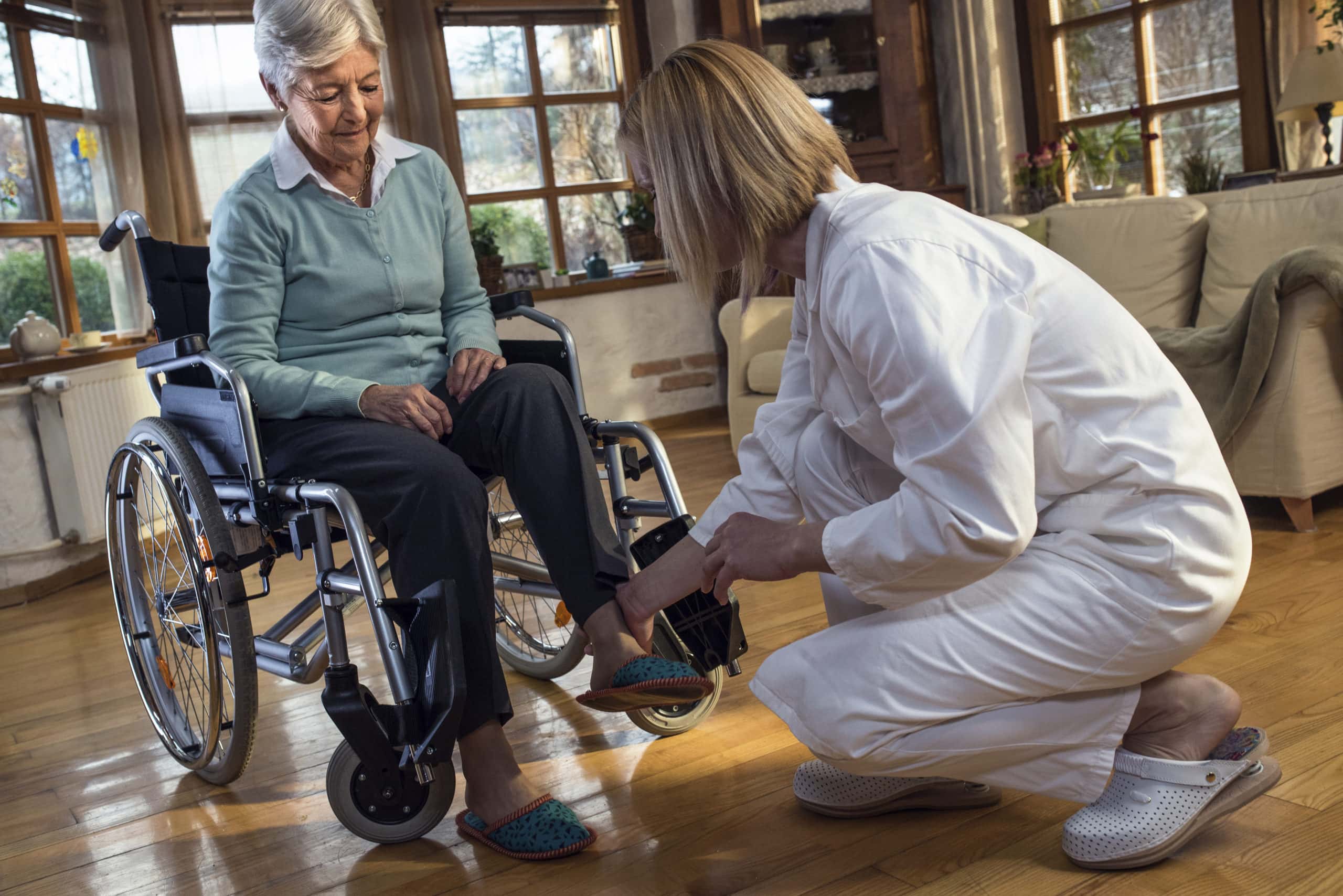 Nurse during home visit with senior woman
