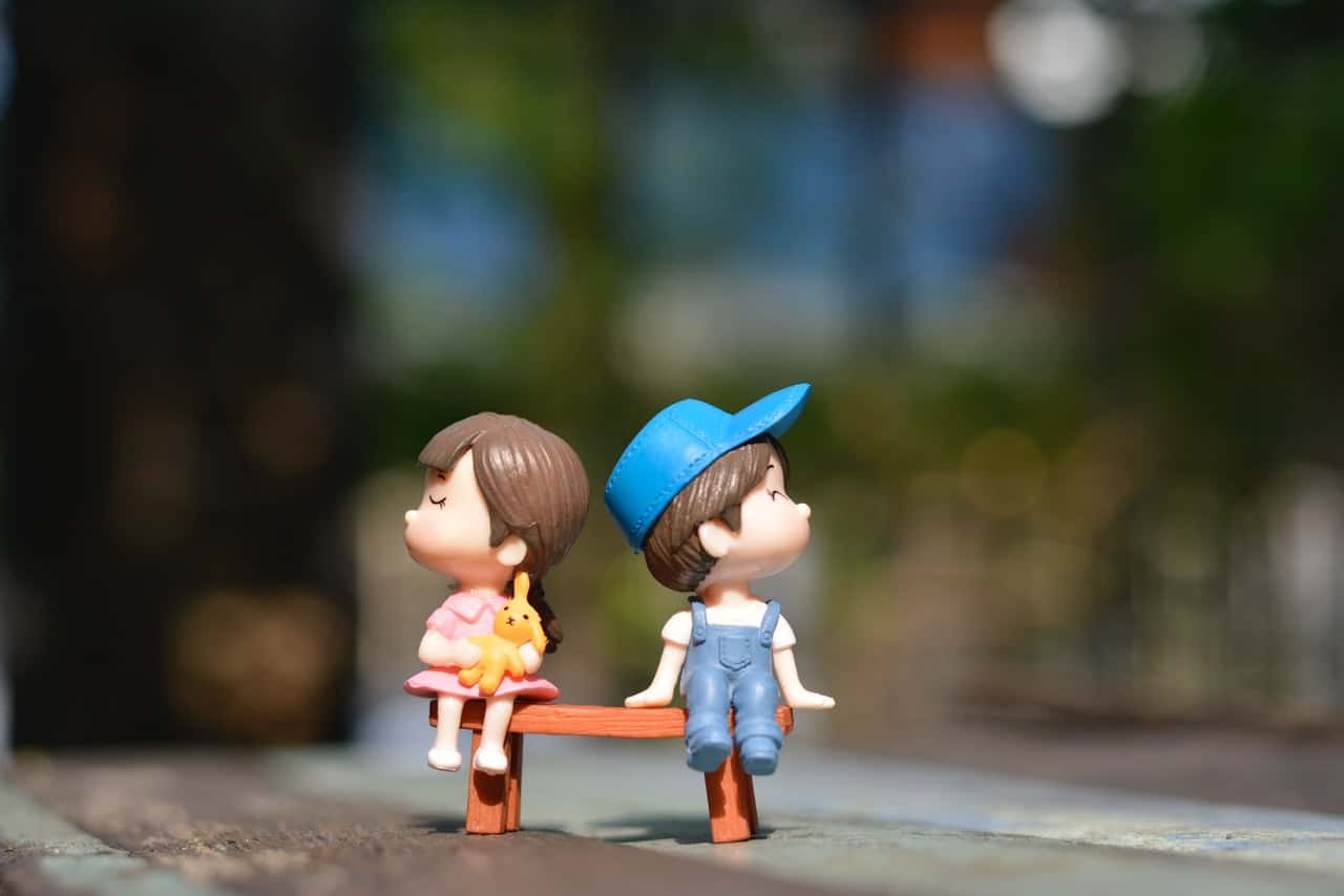 boy-and-girl-sitting-on-bench-toy-1767434