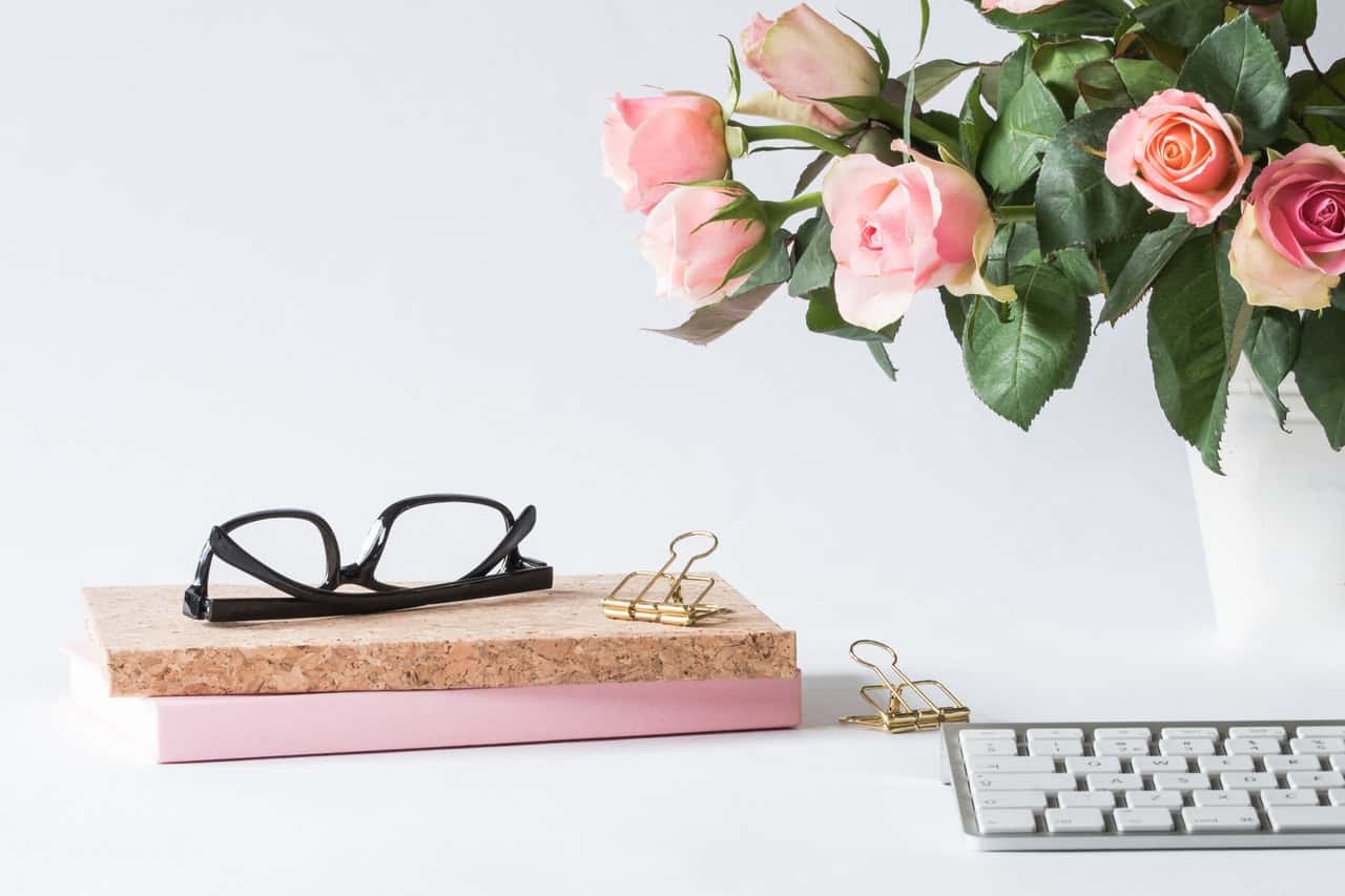 eyeglasses-on-book-beside-rose-and-keyboard-2008143