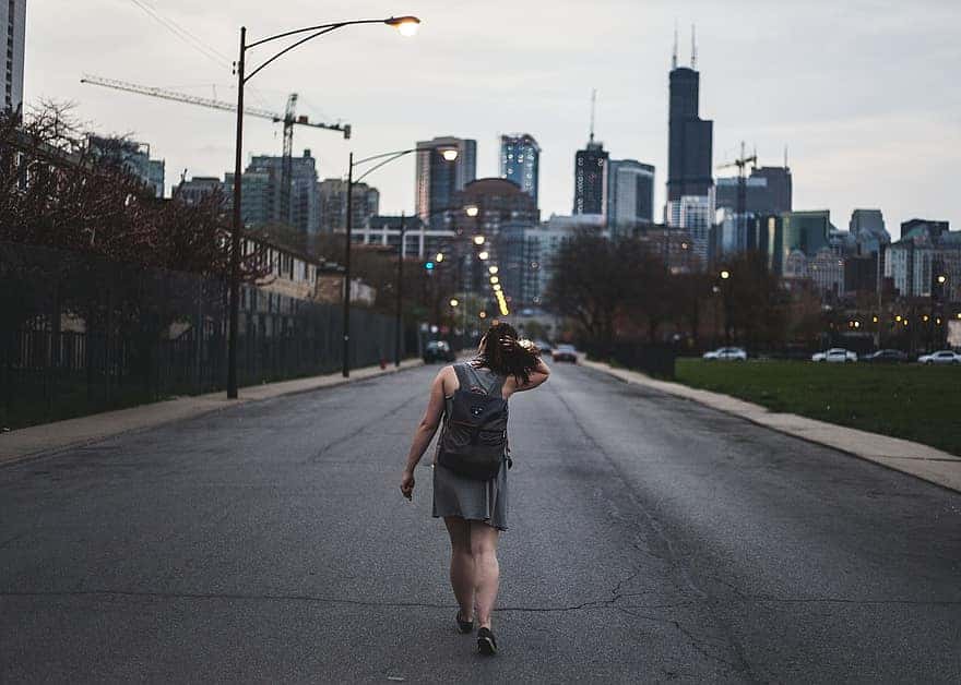 girl-alone-thinking-walking-street-road-car-building-structure