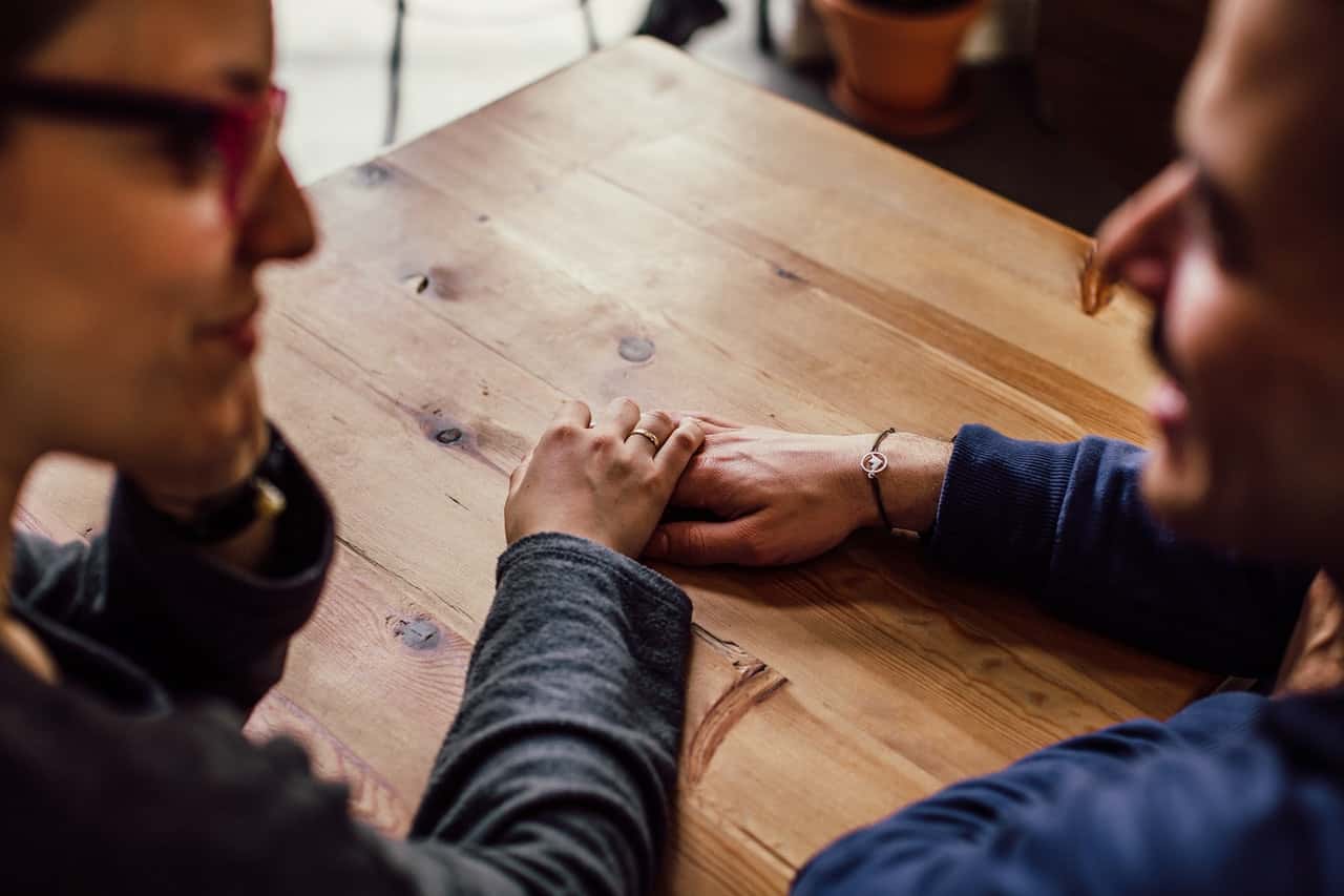 man-and-woman-sitting-together-in-front-of-table-951290
