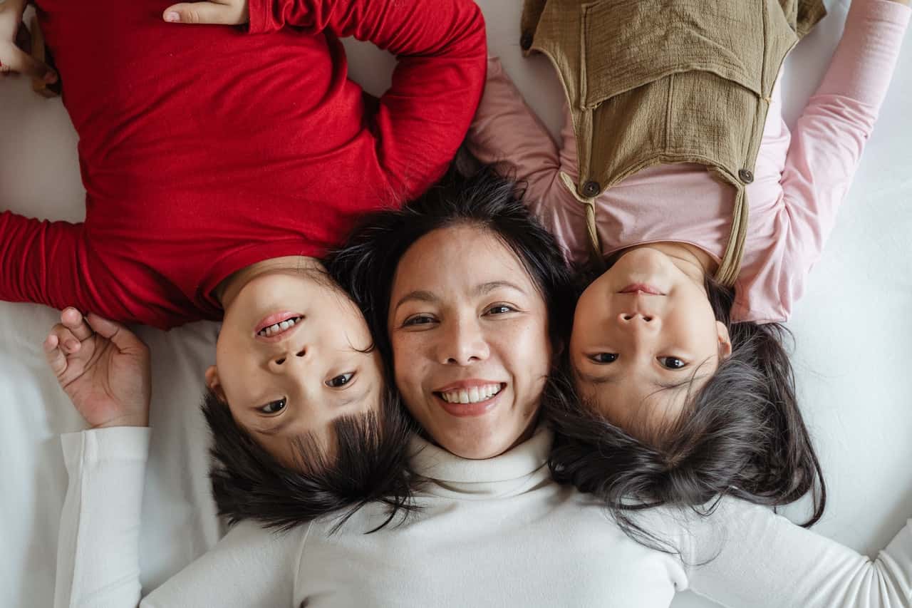 photo-of-woman-and-her-children-lying-on-bed-4473870