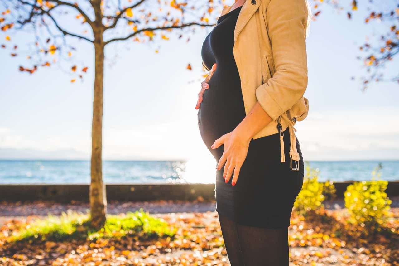 pregnant-woman-wearing-beige-long-sleeve-shirt-standing-near-132730