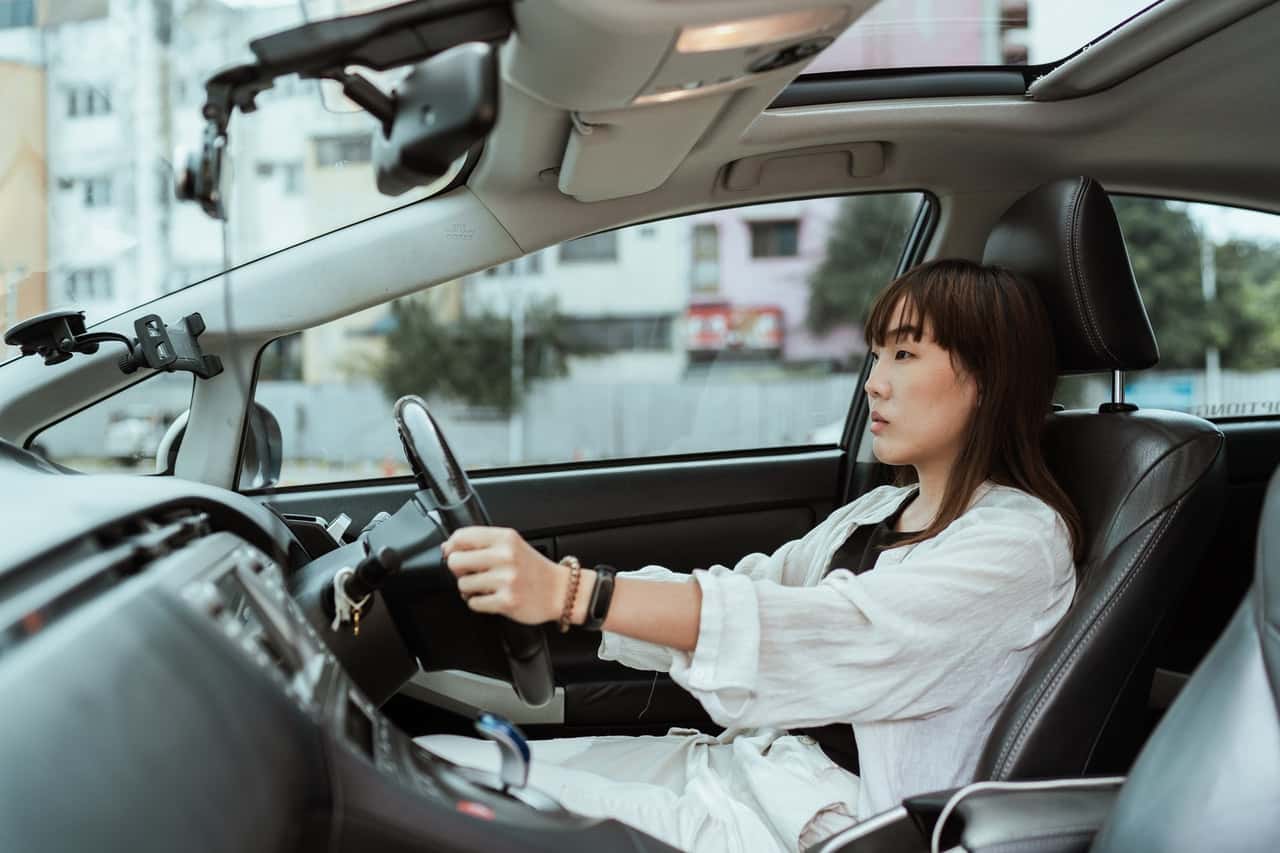 serious-asian-woman-driving-right-hand-car-4429509