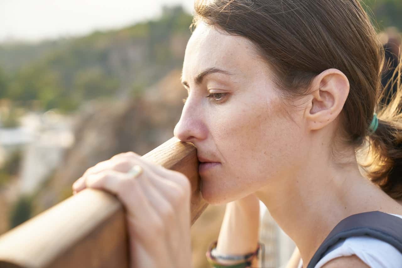 woman-standing-in-front-of-brown-wood-plank-1458826