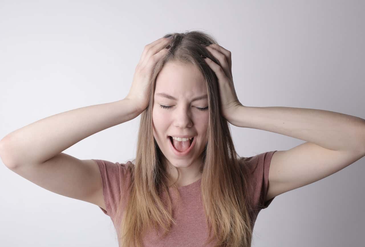 young-frustrated-woman-screaming-with-closed-eyes-3885618