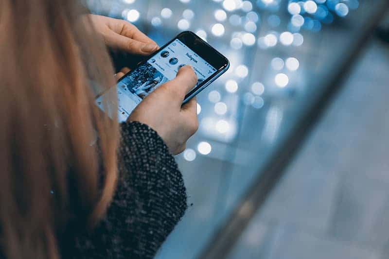 young-girl-uses-smartphone-with-instagram-app