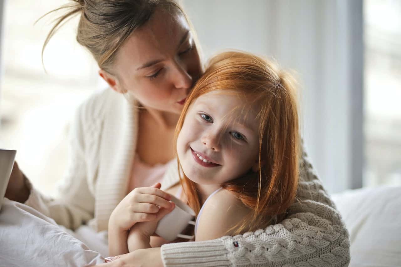 a-mother-kissing-her-child-3760279
