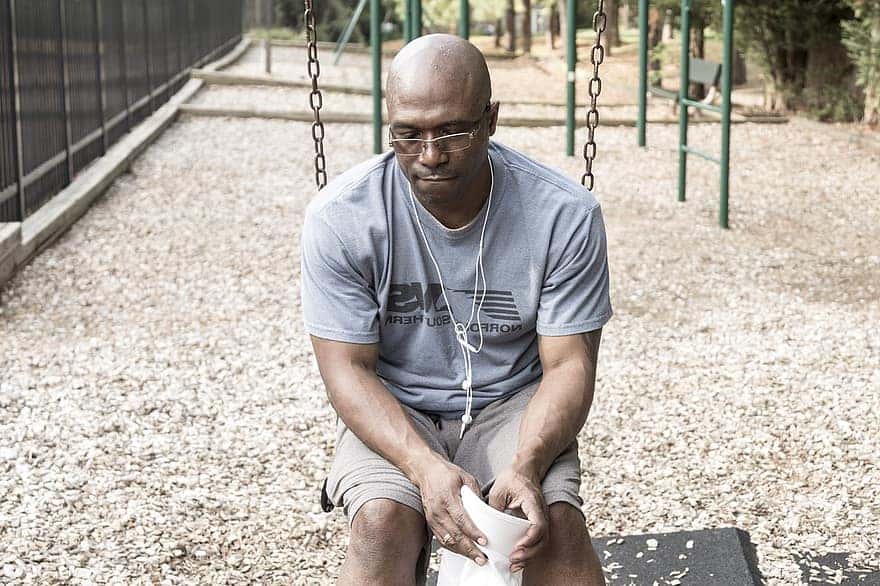 caribbean-man-generation-x-depressed-man-on-a-swing-suicidal-man-in-a-playground-black-man