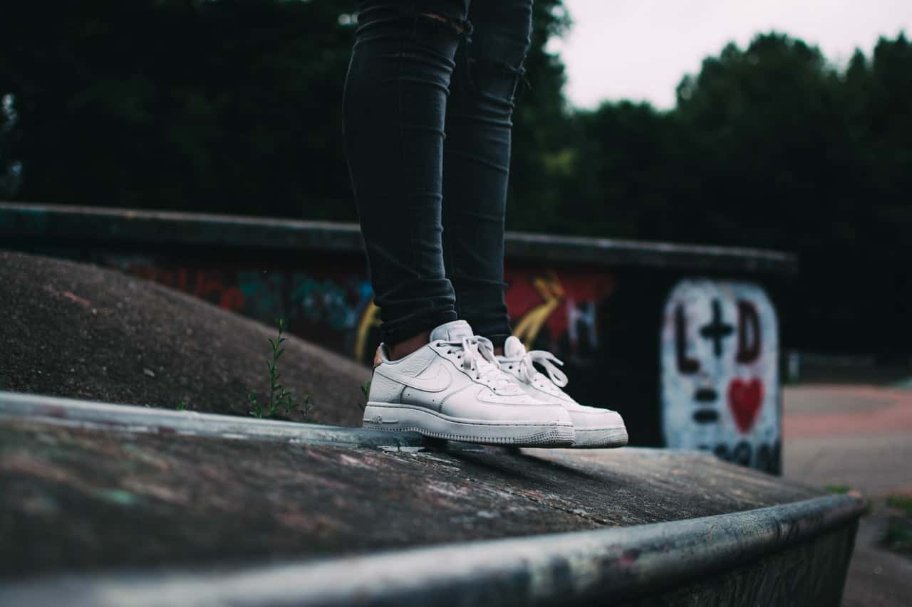 human-standing-on-the-ground-and-wearing-white-nike-sneakers-671915