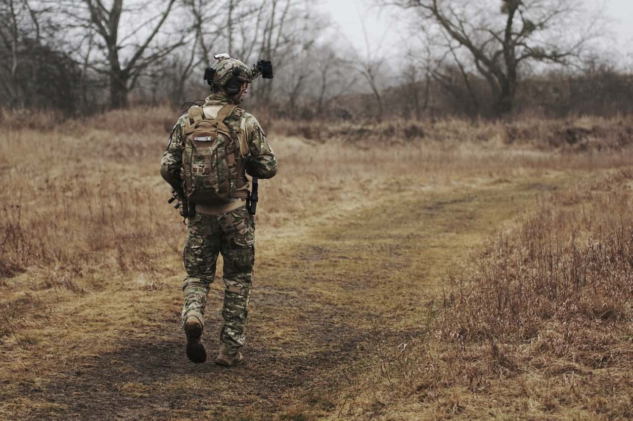 man-wearing-military-uniform-and-walking-through-woods-1927974